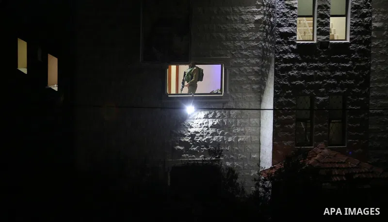 Israeli soldiers take position as an excavator destroys the house of Palestinian man Ashraf Naalwa in the village of Shuwaykah, near the West Bank city of Tulkarem, on December 17, 2018. Ashraf Naalwa was killed on Decem...
