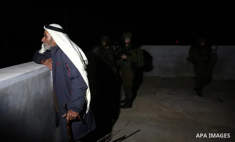 Israeli soldiers take position as an excavator destroys the house of Palestinian man Ashraf Naalwa in the village of Shuwaykah, near the West Bank city of Tulkarem, on December 17, 2018. Ashraf Naalwa was killed on Decem...