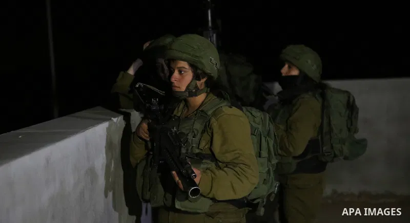 Israeli soldiers take position as an excavator destroys the house of Palestinian man Ashraf Naalwa in the village of Shuwaykah, near the West Bank city of Tulkarem, on December 17, 2018. Ashraf Naalwa was killed on Decem...