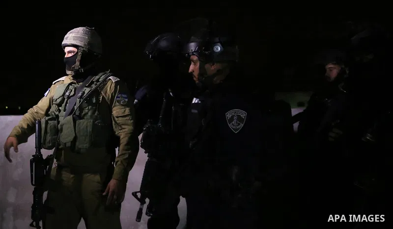 Israeli soldiers take position as an excavator destroys the house of Palestinian man Ashraf Naalwa in the village of Shuwaykah, near the West Bank city of Tulkarem, on December 17, 2018. Ashraf Naalwa was killed on Decem...