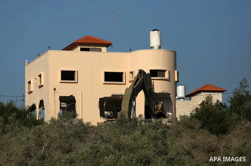 An excavator of the Israeli forces destroys the house of Palestinian man Ashraf Naalwa in the village of Shuwaykah, near the West Bank city of Tulkarem, on December 17, 2018. - Ashraf Naalwa was killed on December 12 by...