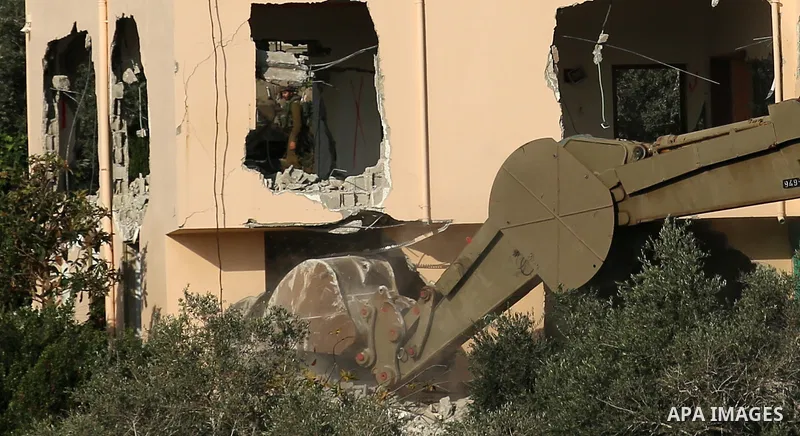 An excavator of the Israeli forces destroys the house of Palestinian man Ashraf Naalwa in the village of Shuwaykah, near the West Bank city of Tulkarem, on December 17, 2018. - Ashraf Naalwa was killed on December 12 by...