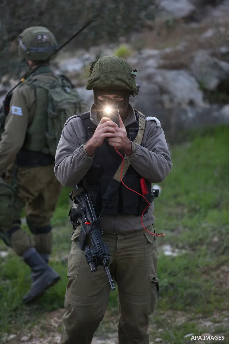 Israeli soldiers take position as an excavator destroys the house of Palestinian man Ashraf Naalwa in the village of Shuwaykah, near the West Bank city of Tulkarem, on December 17, 2018. Ashraf Naalwa was killed on Decem...