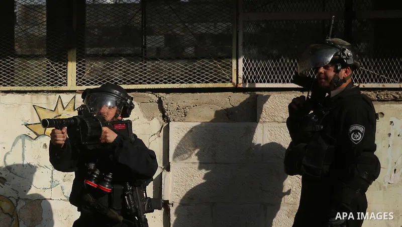 Israeli soldiers take position as an excavator destroys the house of Palestinian man Ashraf Naalwa in the village of Shuwaykah, near the West Bank city of Tulkarem, on December 17, 2018. Ashraf Naalwa was killed on Decem...