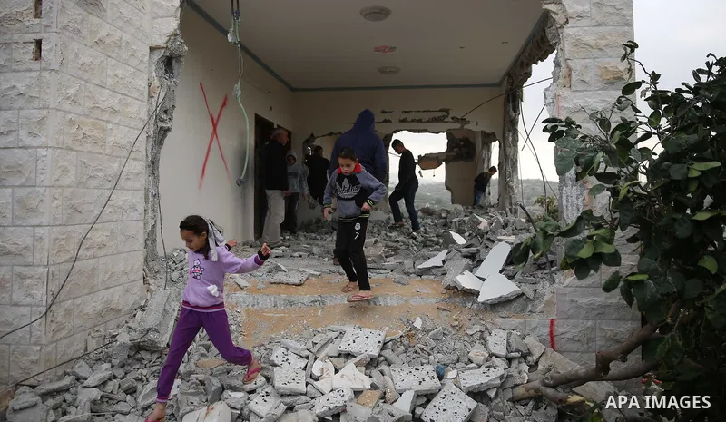 Palestinians inspect the house of Ashraf Naalwa after Israeli forces destroyed it in the village of Shuwaykah, near the West Bank city of Tulkarem, on December 17, 2018. Ashraf Naalwa was killed on December 12 by Israeli...