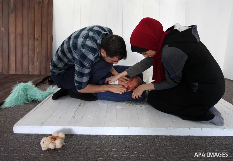 Yahya Barzaq, 28, a Palestinian photographer prepares a new born baby for a photograph during a photo session at his studio in Gaza city, December 17, 2018. Photo by Mahmoud Ajjour