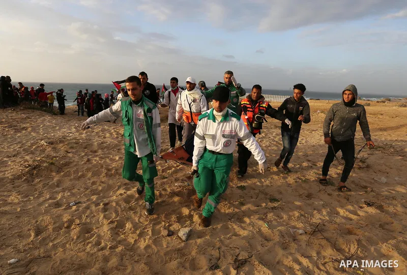 Palestinian protesters gather during clashes with Israeli forces in a demonstration against the Israeli blockade on Gaza Strip, along the Gaza sea barrier on the maritime border with Israel near Kibbutz Zikim, north of B...