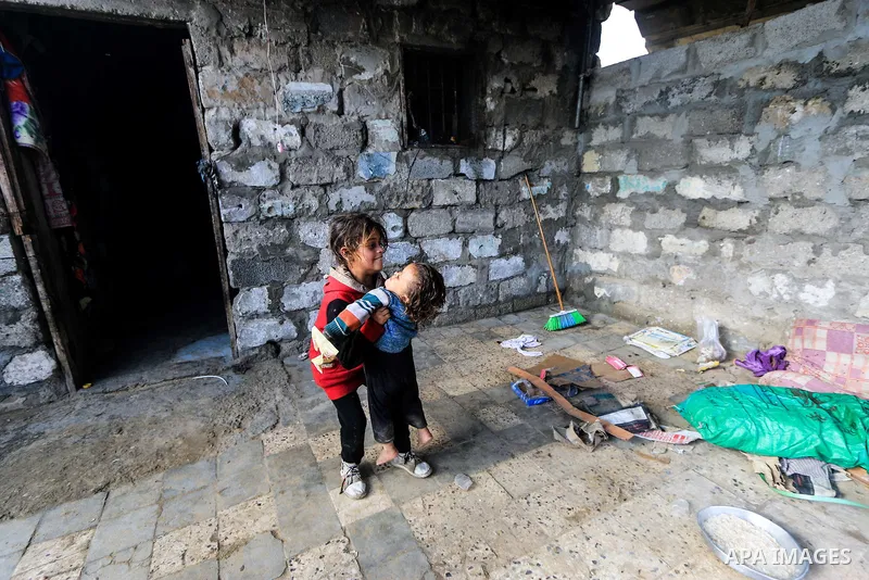 A picture taken on December 20, 2018 shows Palestinian children play outside their family's dwelling during winter season at Nahr al-Bared refugee camp in Khan Younis in the southern Gaza Strip. Photo by Mahmoud Khattab