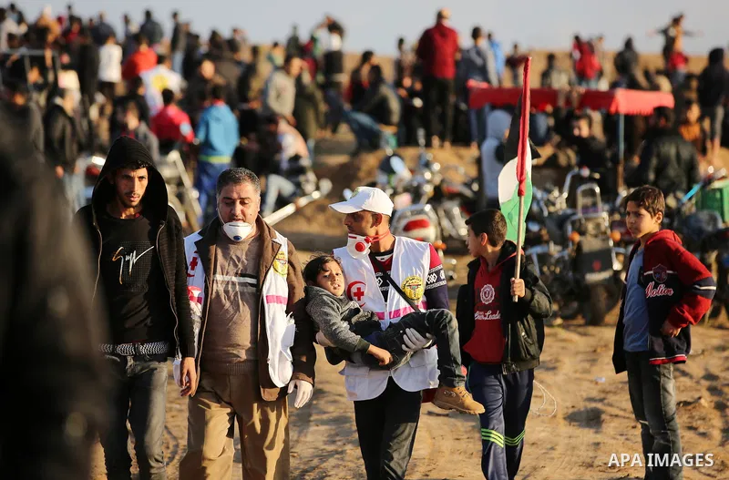 Palestinian protesters gather during clashes with Israeli troops in tents protest where Palestinians demand the right to return to their homeland at the Israel-Gaza border, in east of Gaza City on December 21, 2018. Phot...