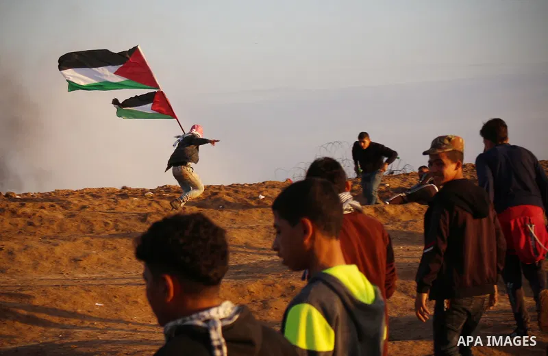 Palestinian protesters gather during clashes with Israeli troops in tents protest where Palestinians demand the right to return to their homeland at the Israel-Gaza border, in east of Gaza City on December 21, 2018. Phot...