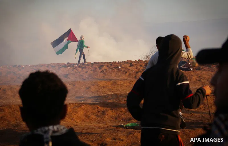 Palestinian protesters gather during clashes with Israeli troops in tents protest where Palestinians demand the right to return to their homeland at the Israel-Gaza border, in east of Gaza City on December 21, 2018. Phot...