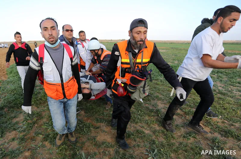 A wounded Palestinian protester is evacuated during clashes with Israeli troops in tents protest where Palestinians demand the right to return to their homeland at the Israel-Gaza border, in Khan Younis in the southern G...