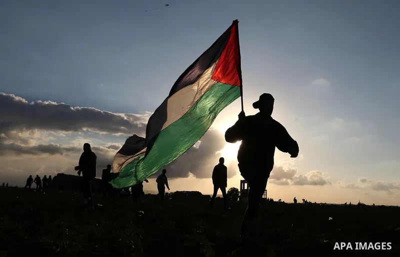 Palestinian protesters gather during clashes with Israeli troops in tents protest where Palestinians demand the right to return to their homeland at the Israel-Gaza border, in Khan Younis in the southern Gaza Strip on De...