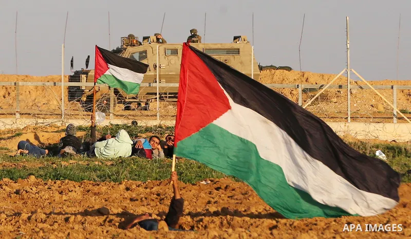 Palestinian protesters gather during clashes with Israeli troops in tents protest where Palestinians demand the right to return to their homeland at the Israel-Gaza border, in Khan Younis in the southern Gaza Strip on De...