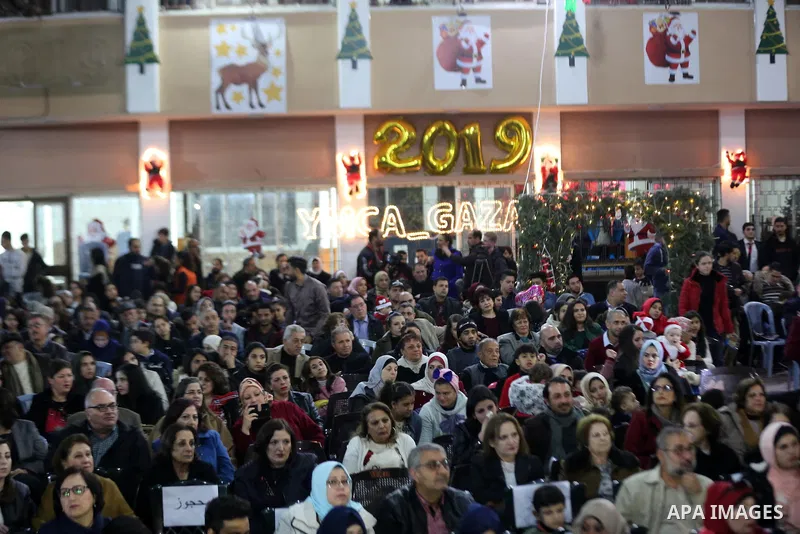Christian Palestinians attend Christmas Tree lighting ceremony in Gaza city on December 22, 2018. Photo by Ashraf Amra