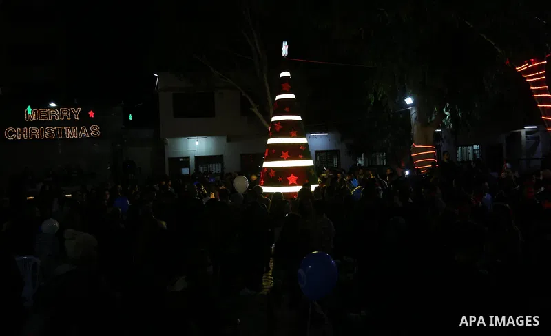 Palestinian Christians attend Christmas Tree lighting ceremony in Gaza city on December 22, 2018. Photo by Ashraf Amra