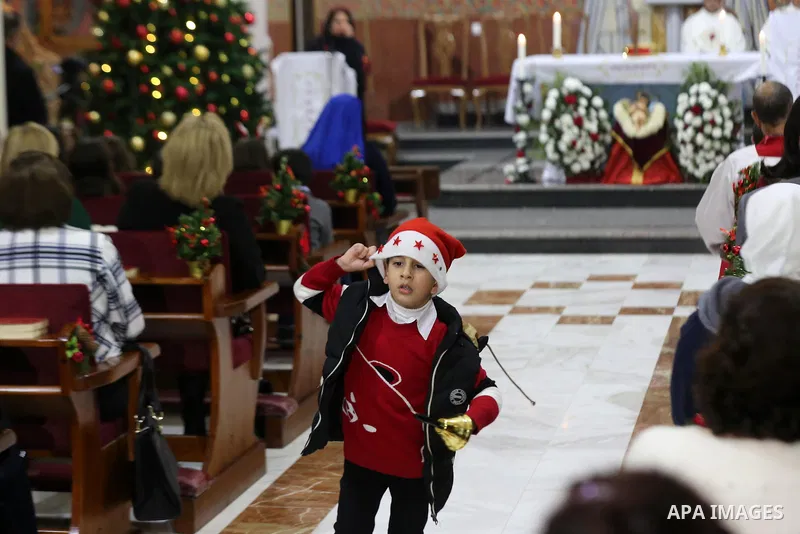 Palestinian Christians attend a prayer at the latin church on the eve of the Christmas celebration, in Gaza city on December 24, 2018. Photo by Ashraf Amra