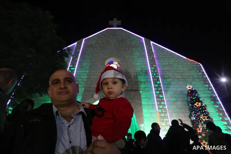 Palestinian Christians attend a prayer at the latin church on the eve of the Christmas celebration, in Gaza city on December 24, 2018. Photo by Ashraf Amra