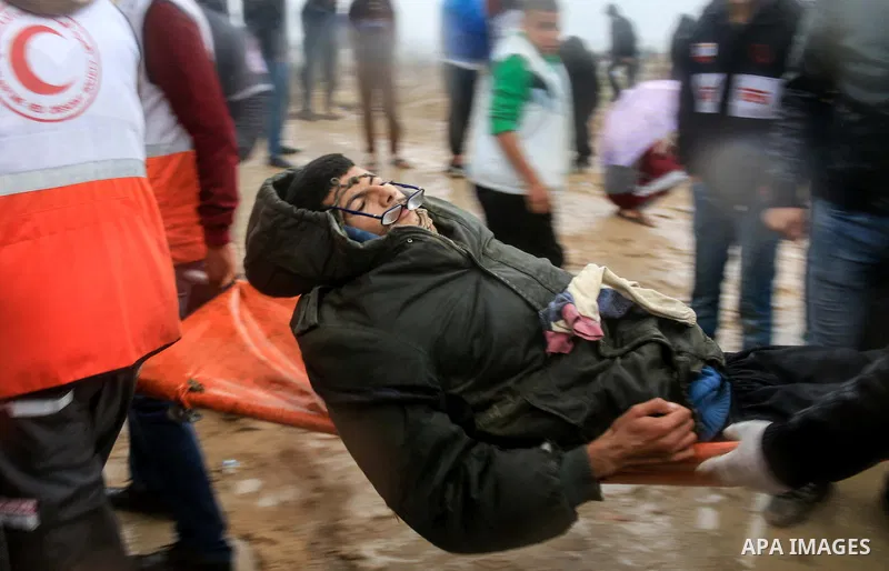 Palestinian protesters gather during clashes with Israeli troops in tents protest where Palestinians demand the right to return to their homeland at the Israel-Gaza border, in al-Bureij in the center of Gaza Strip on Dec...