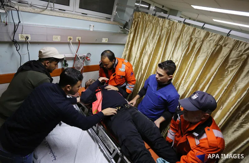 A Palestinian paramedic who was wounded during clashes between Palestinian protesters and Israeli troops on Israel-Gaza border, receives treatment at a hospital in Khan Younis in the southern Gaza Strip on December 28, 2...