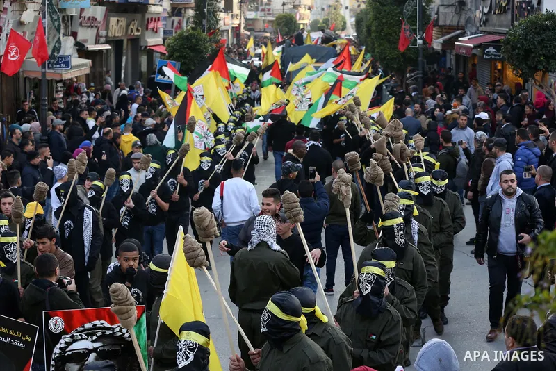 Palestinians take part during a rally marking the 54th anniversary of Fatah's founding, in the West Bank city of Ramallah, on December 31, 2018. Photo by Ahmad Arouri