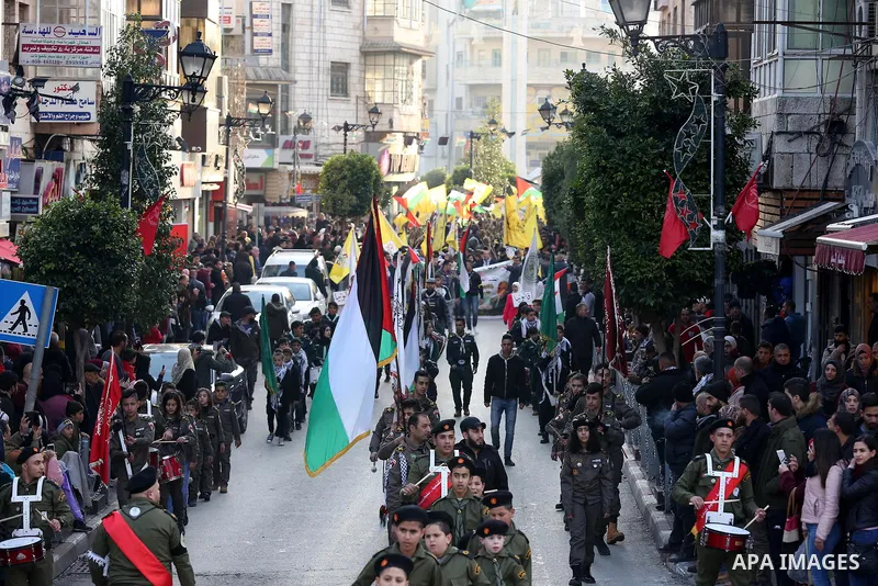 Palestinian scouts perform during a rally marking the 54th anniversary of Fatah's founding, in the West Bank city of Ramallah, on December 31, 2018. Photo by Ahmad Arouri
