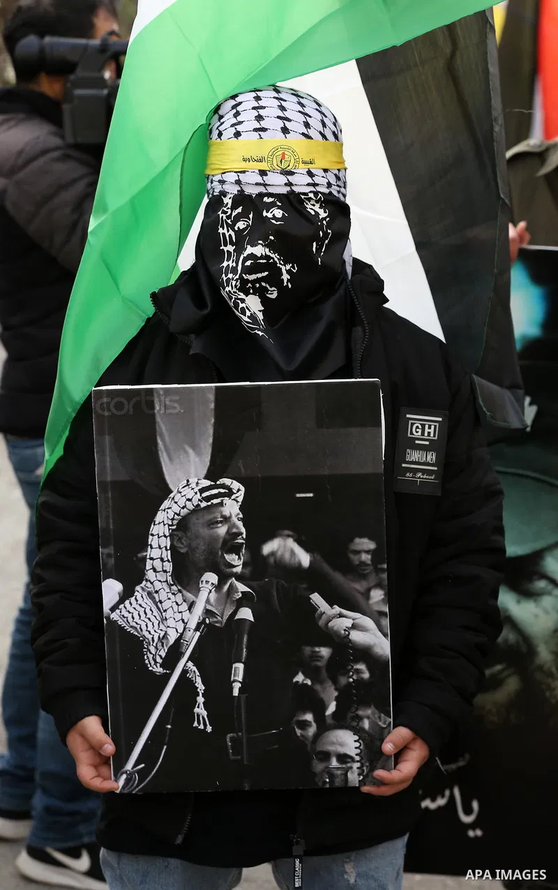Palestinians take part during a rally marking the 54th anniversary of Fatah's founding, in the West Bank city of Ramallah, on December 31, 2018. Photo by Ahmad Arouri
