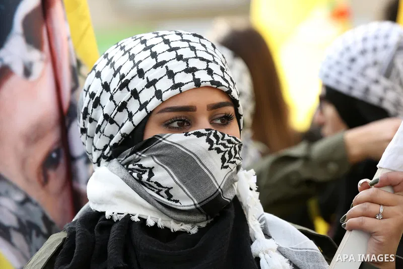 Palestinians take part during a rally marking the 54th anniversary of Fatah's founding, in the West Bank city of Ramallah, on December 31, 2018. Photo by Ahmad Arouri