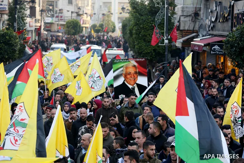 Palestinians take part during a rally marking the 54th anniversary of Fatah's founding, in the West Bank city of Ramallah, on December 31, 2018. Photo by Ahmad Arouri