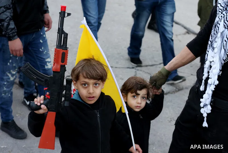Palestinians take part during a rally marking the 54th anniversary of Fatah's founding, in the West Bank city of Ramallah, on December 31, 2018. Photo by Ahmad Arouri