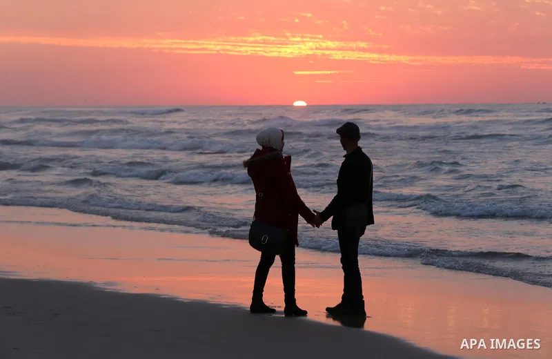 Palestinians enjoy their time on the beach during sunset in the last day of 2018, a few hours prior to the new year's celebrations, in Gaza city on December 31, 2018. Photo by Ashraf Amra
