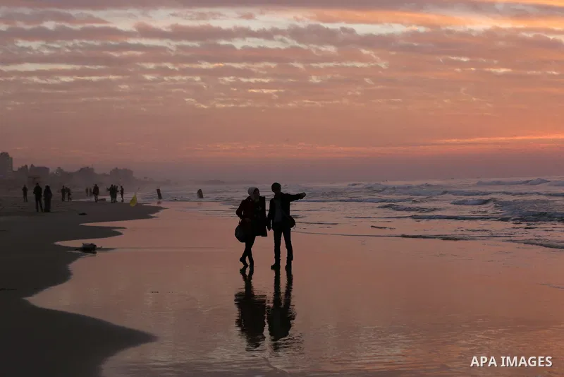 Palestinians enjoy their time on the beach during sunset in the last day of 2018, a few hours prior to the new year's celebrations, in Gaza city on December 31, 2018. Photo by Ashraf Amra