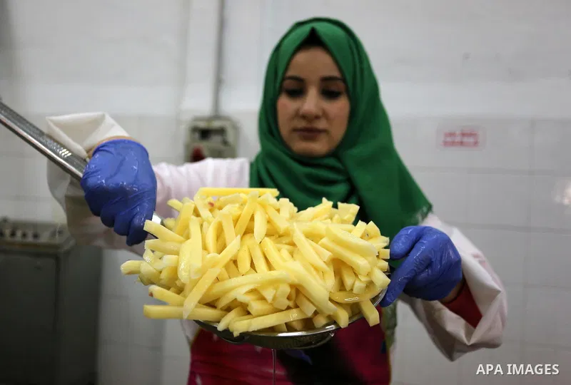 Palestinia laborers work at a frozen potato chips factory, in Beit Hanoun in the northern Gaza Strip, on January 22, 2019. The potatoes have been washed and peeled and are being checked for bruising and rot before packag...