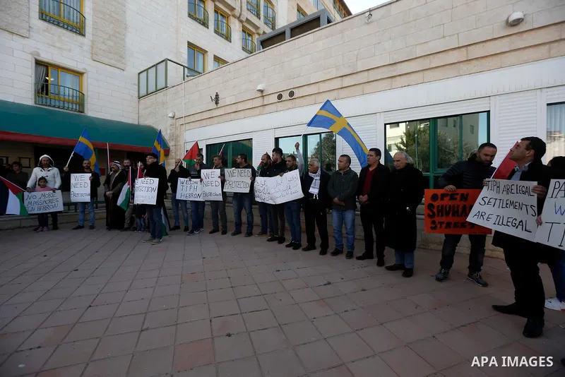 Palestinian protesters take part in a protest against Israeli Prime Minister Benjamin Netanyahu's decision not to renew the mandate of the Temporary International Presence in Hebron (TIPH), in the West Bank city of Hebro...