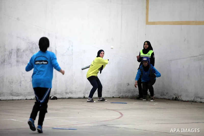 Palestinian female players of al-Nasr al-Arabi club, compete with players of Amwaj society club, during final baseball match, in Gaza city on January 31, 2019. Photo by Mahmoud Ajjour