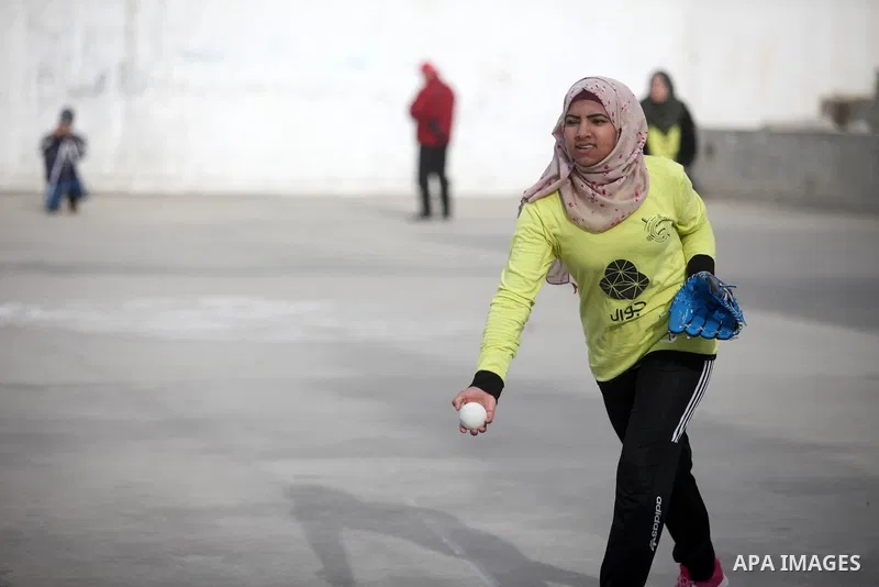 Palestinian female players of al-Nasr al-Arabi club, compete with players of Amwaj society club, during final baseball match, in Gaza city on January 31, 2019. Photo by Mahmoud Ajjour