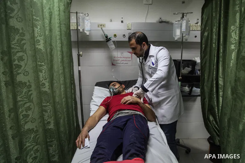 A paramedic treats a Palestinian protester, who was injured by Israeli security force during a protest near the Israeli settlement of Kibbutz Zikim, at a hospital in Jabalia in the northern Gaza strip on February 12, 201...