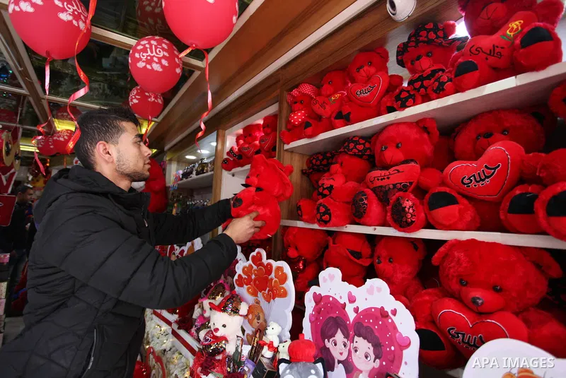 Palestinian vendors display flowers, red teddy bears, red ballons and pillows on Valentine's day, in Gaza city on February 14, 2019. Valentine's Day is increasingly popular in the region as people have taken up the custo...