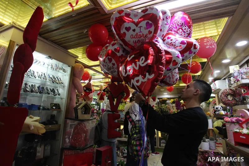 Palestinian vendors display flowers, red teddy bears, red ballons and pillows on Valentine's day, in Gaza city on February 14, 2019. Valentine's Day is increasingly popular in the region as people have taken up the custo...