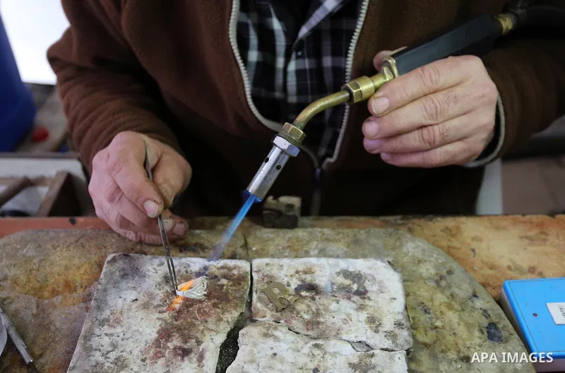 A Palestnian goldsmith Nicolae Terzi, 62, makes jewellery at his workshop, in Khan Younis in the southern of Gaza strip, on February 14, 2019. Terzi has jewellery-making skills as he trained in the profession in Italy si...