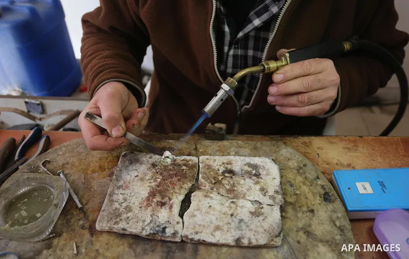 A Palestnian goldsmith Nicolae Terzi, 62, makes jewellery at his workshop, in Khan Younis in the southern of Gaza strip, on February 14, 2019. Terzi has jewellery-making skills as he trained in the profession in Italy si...