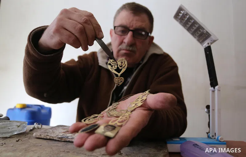 A Palestnian goldsmith Nicolae Terzi, 62, makes jewellery at his workshop, in Khan Younis in the southern of Gaza strip, on February 14, 2019. Terzi has jewellery-making skills as he trained in the profession in Italy si...