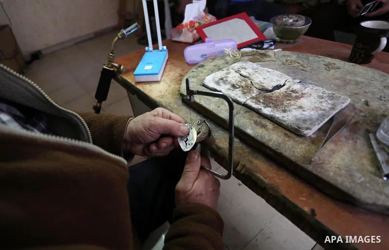 A Palestnian goldsmith Nicolae Terzi, 62, makes jewellery at his workshop, in Khan Younis in the southern of Gaza strip, on February 14, 2019. Terzi has jewellery-making skills as he trained in the profession in Italy si...