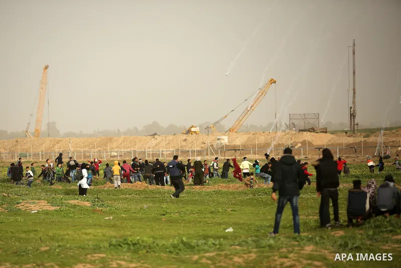 Palestinian protesters clash with Israeli troops following the tents protest where Palestinians demand the right to return to their homeland at the Israel-Gaza border, in the east of Gaza city, February 15, 2019. At leas...