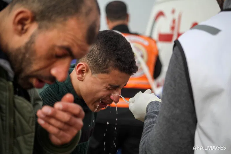 A paramedic treats a Palestinian protester suffers from tear gas fired by Israeli troops during clashes in tents protest where Palestinians demand the right to return to their homeland at the Israel-Gaza border, in Jabal...