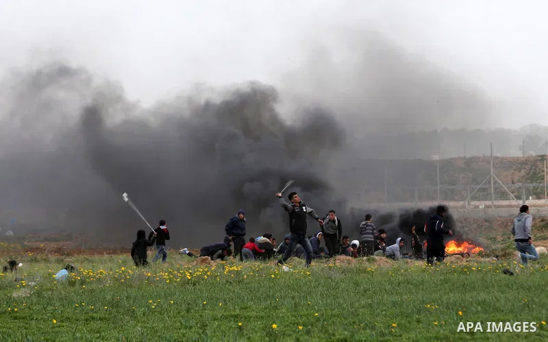 Palestinian protesters gather during clashes with Israeli troops in tents protest where Palestinians demand the right to return to their homeland at the Israel-Gaza border, in Khan Younis in the southern Gaza Strip, on F...