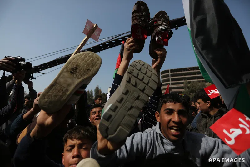 Palestinians take part in a protest against decisions of the Palestinian president Mahmoud Abbas, in Gaza city, on February 24, 2019. Photo by Ashraf Amra