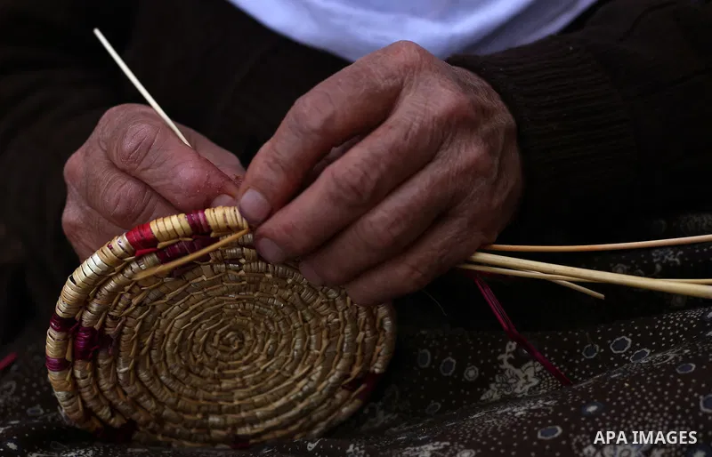 Mariyam Haj Ali, 86-year-old Palestinian woman, makes trays and baskets using wheat and olive straws, at her home in the village of Jama'in near the West Bank city of Nablus, on February 27 2019. Photo by Shadi Jarar'ah