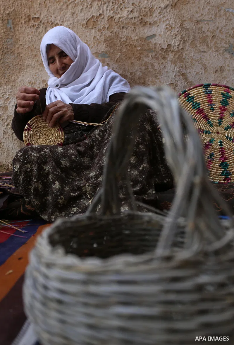 Mariyam Haj Ali, 86-year-old Palestinian woman, makes trays and baskets using wheat and olive straws, at her home in the village of Jama'in near the West Bank city of Nablus, on February 27 2019. Photo by Shadi Jarar'ah