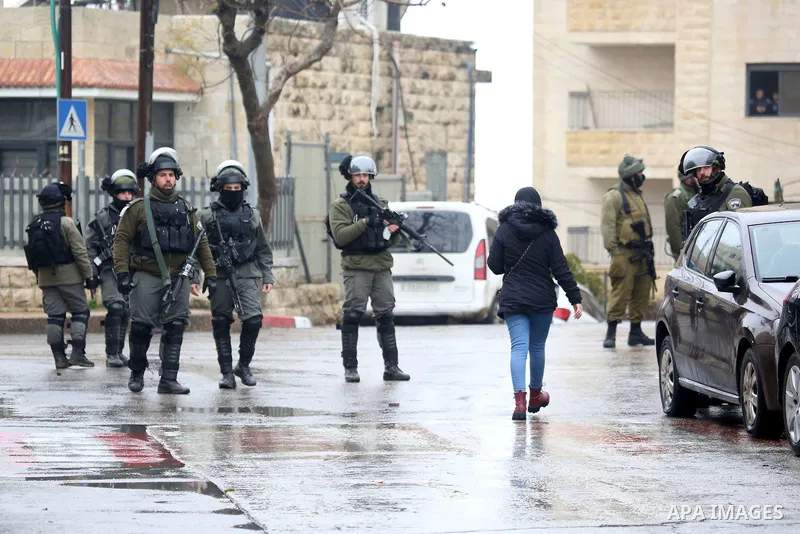 Israeli border policemen take up position during a raid, in the West Bank city of Ramallah, on February 27, 2019. Photo by Ahmad Arouri